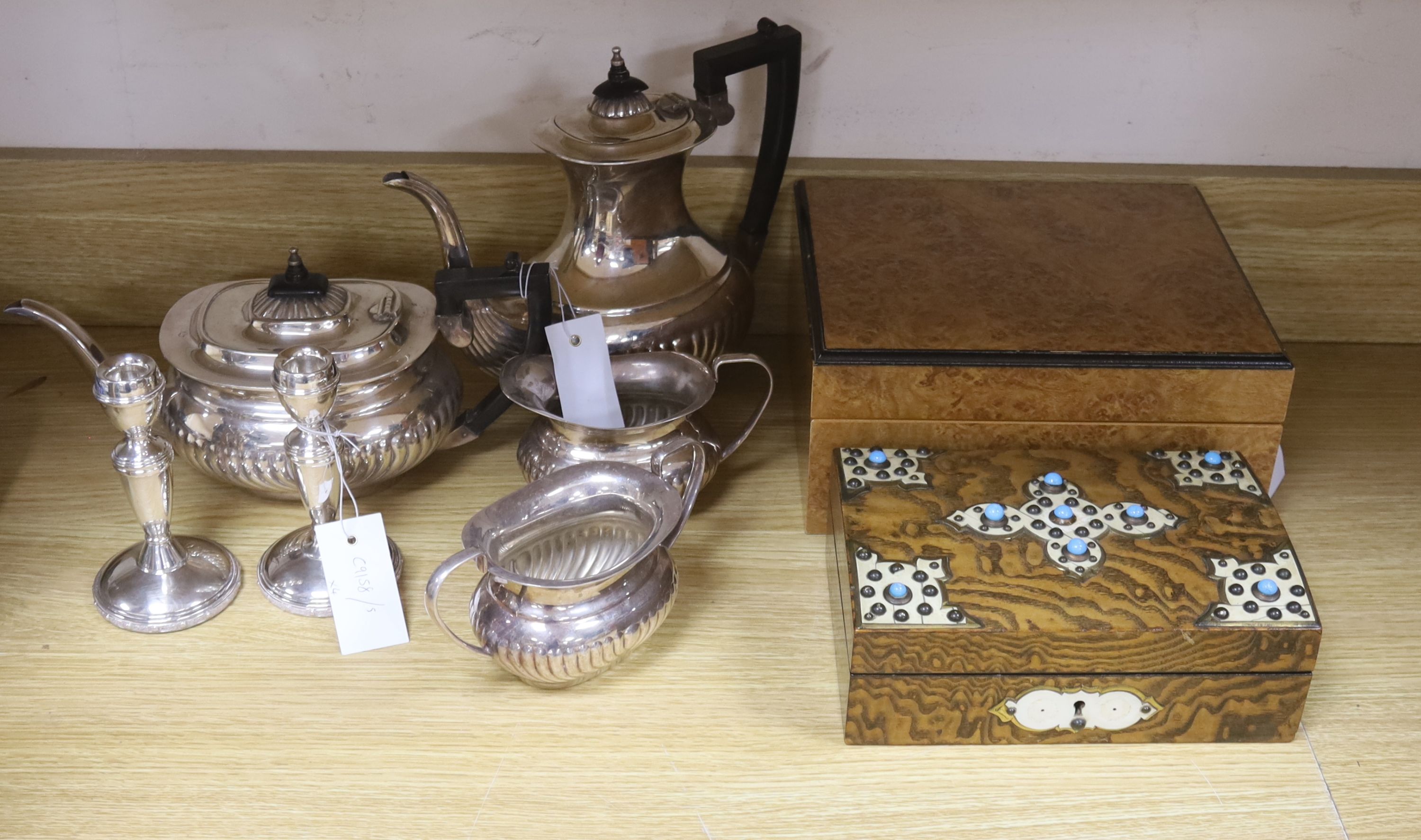 A Victorian studded box, a modern humidor, two candlesticks and a four piece silver plated tea set